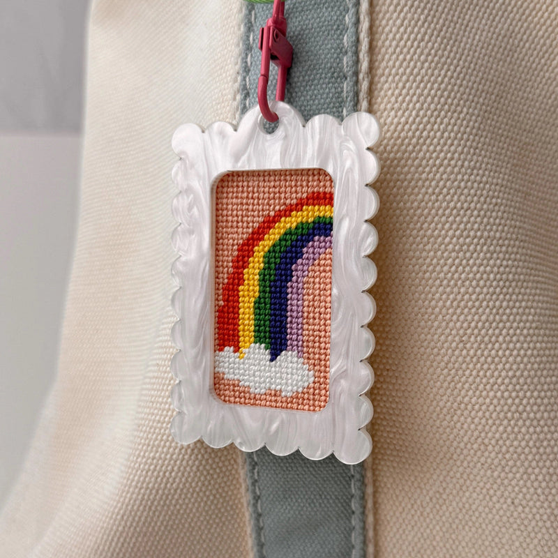 Frame keychain with rainbow needle point on a bag