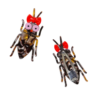 Two cockroach clips with red bows and googly eyes