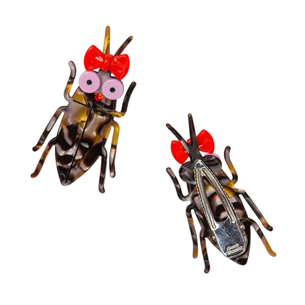 Two cockroach clips with red bows and googly eyes