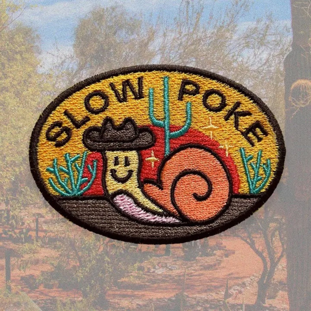 embroidered patch featuring a cowboy snail that says "slow poke"