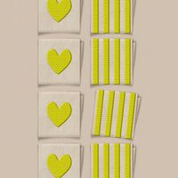 Set of green heart and striped patterned labels on a beige background