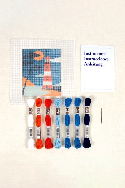Set of embroidery threads with a framed artwork in the background