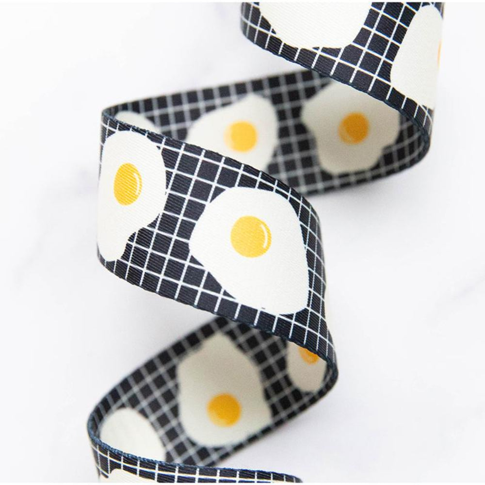 Webbing with fried egg pattern on a white background