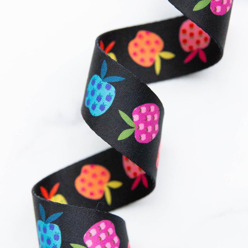 Black webbing with colorful fruit pattern on a white background