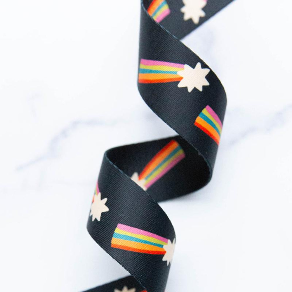 Black webbing with rainbow and star patterns on a white background