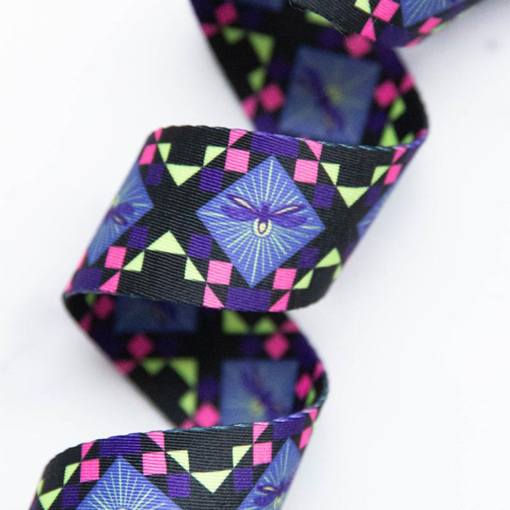 Colorful geometric patterned webbing with a firefly in the center