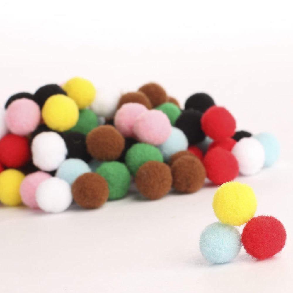 Colorful felt pom-poms on a white background