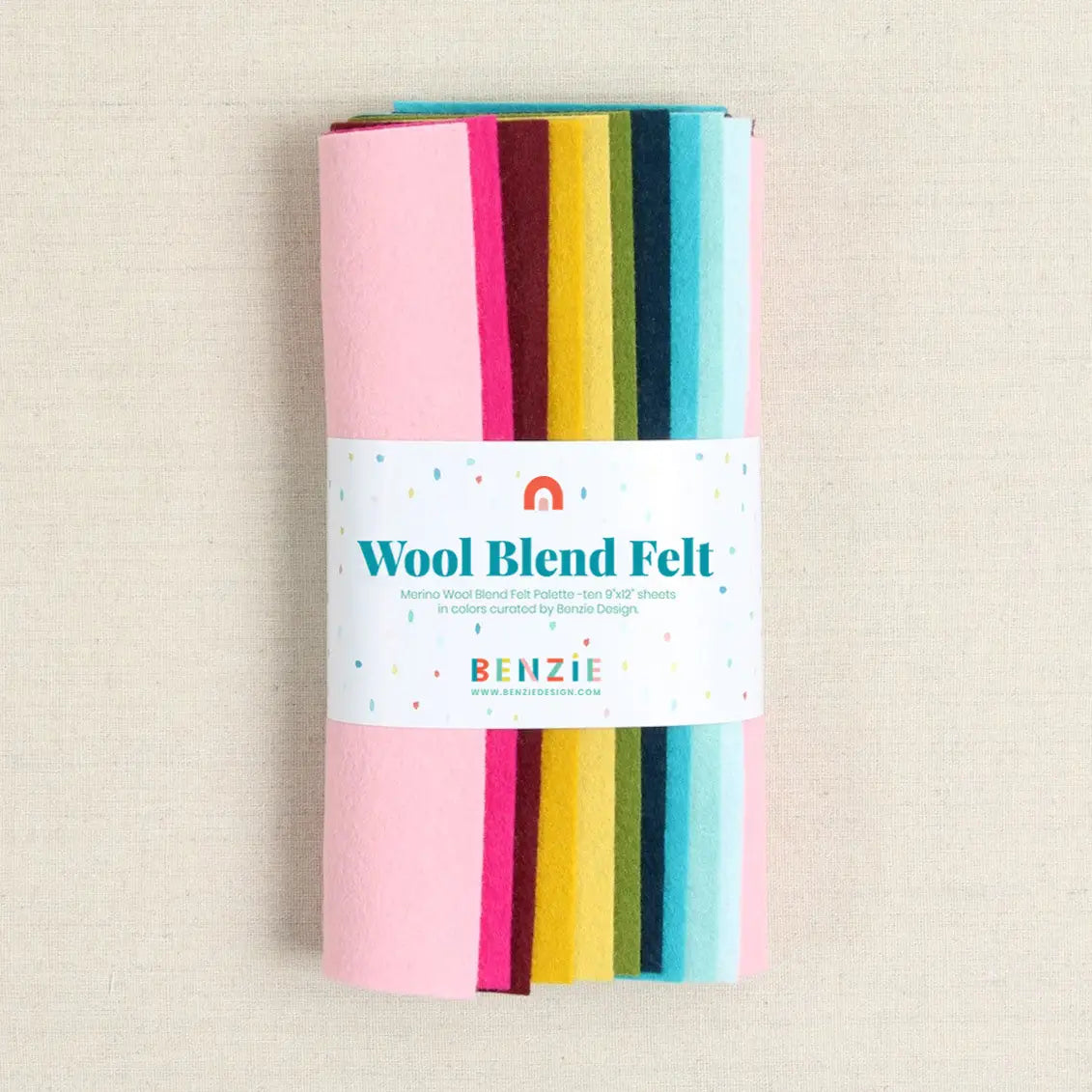Pack of wool blend felt with colorful strips on a beige background