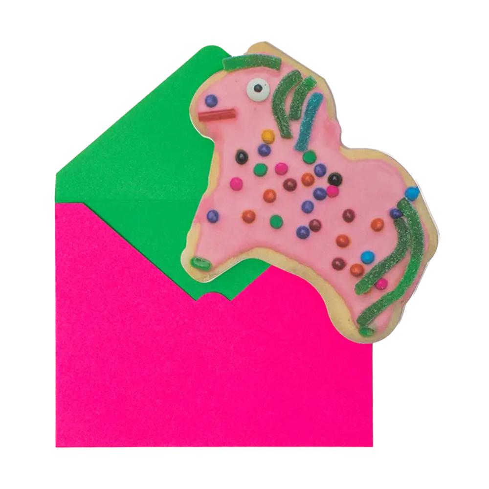 Colorful pony-shaped cookie card with sprinkles on a pink and green background