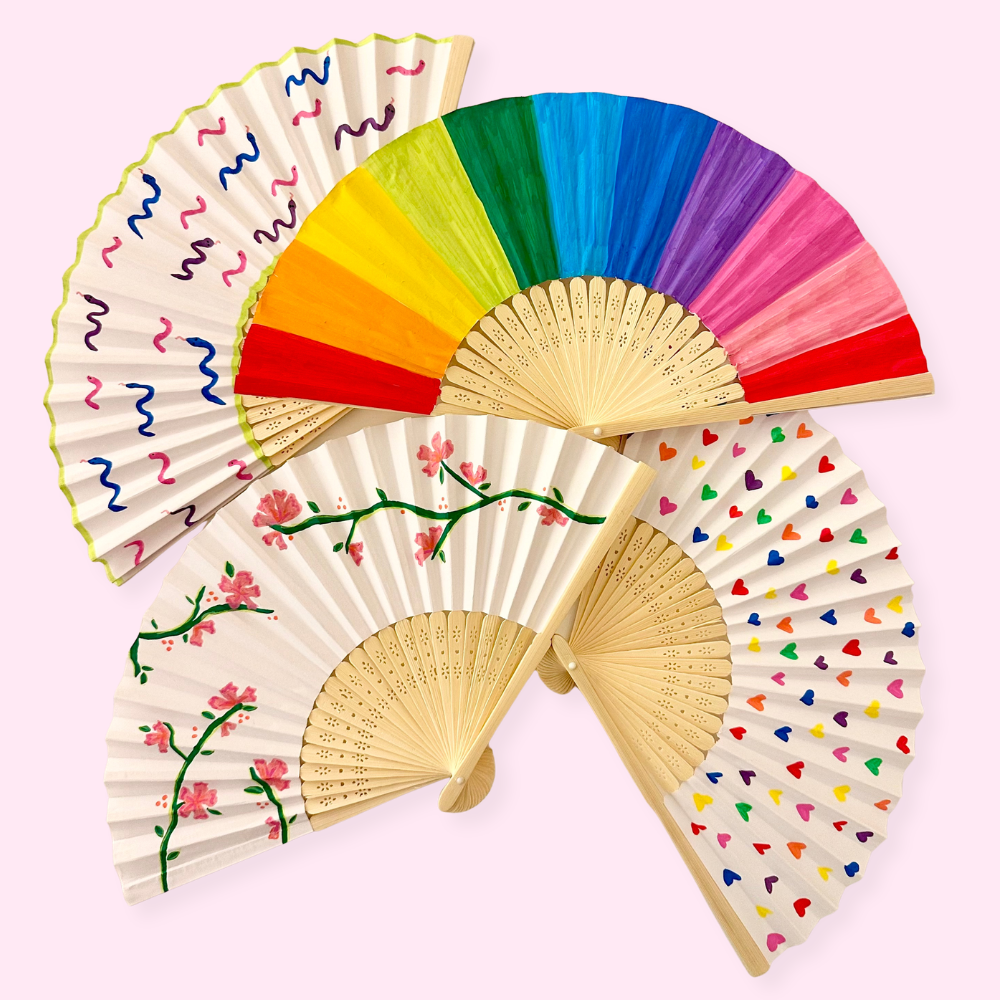 Set of four hand fans with different designs and color schemes on a pink background