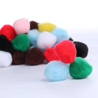 Colorful pom-pom balls on a white background
