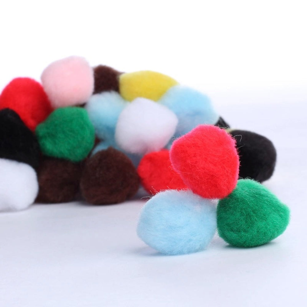 Colorful pom-pom balls on a white background