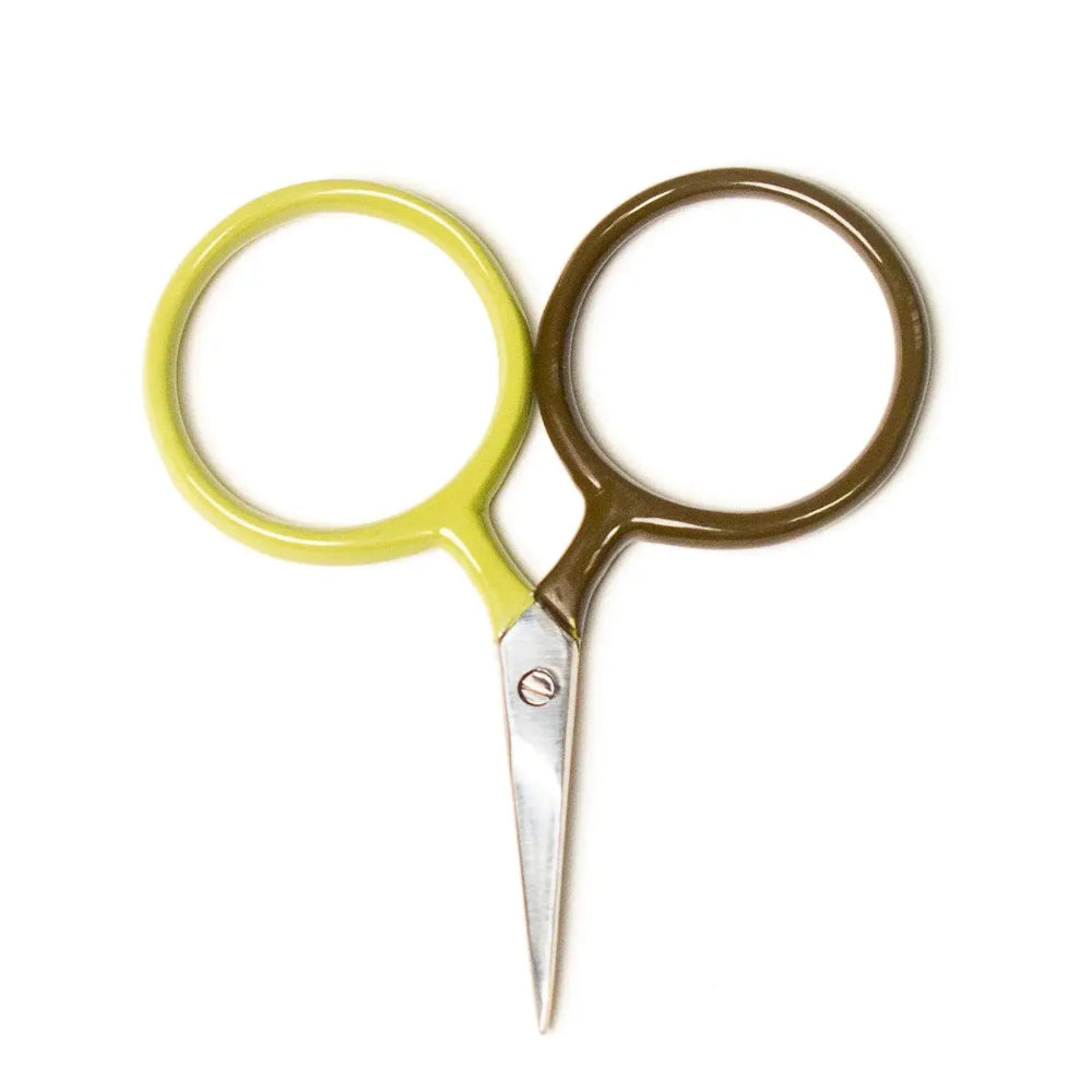 Pair of scissors with yellow handle and gold metal blades on a white background