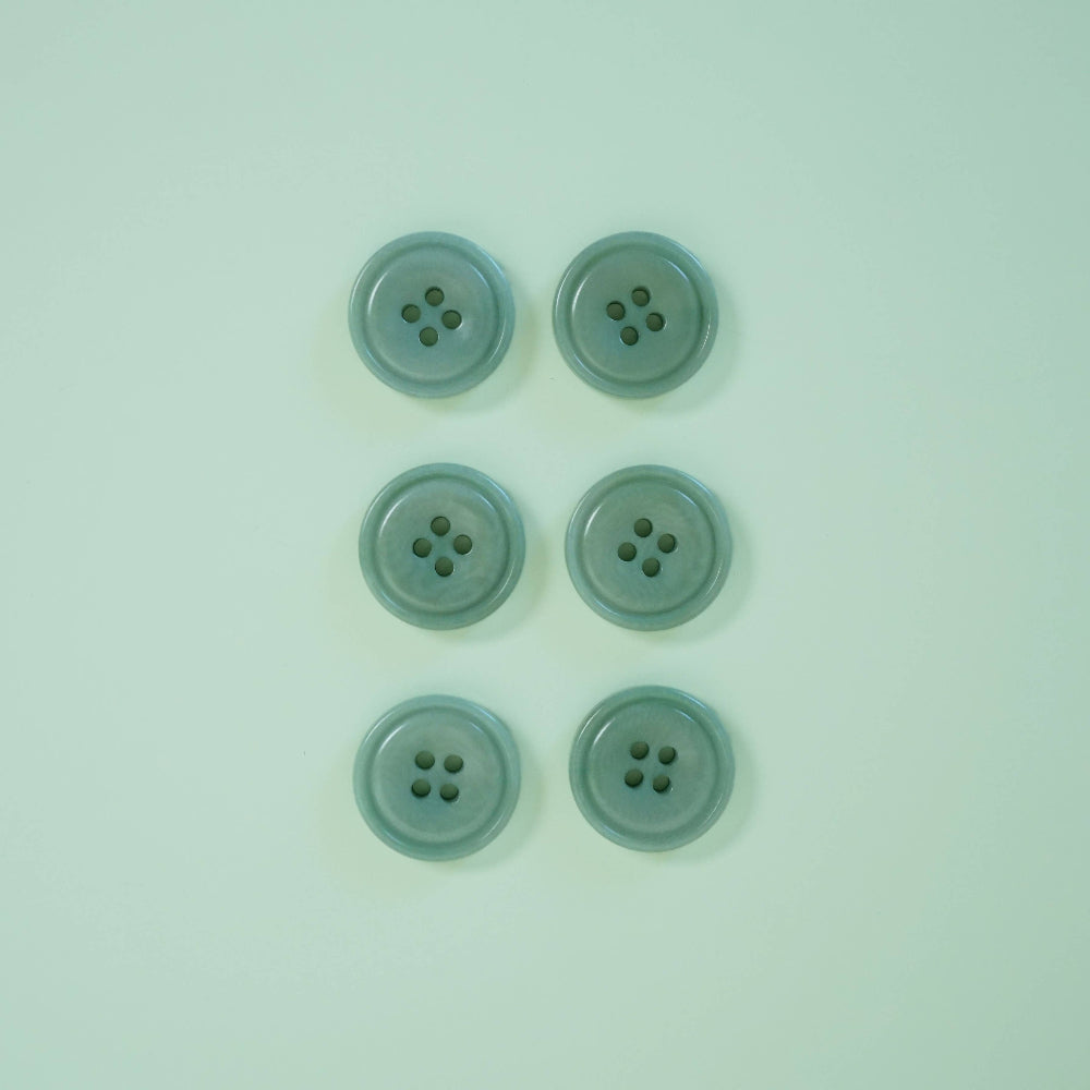 Five light blue buttons on a matching light blue background
