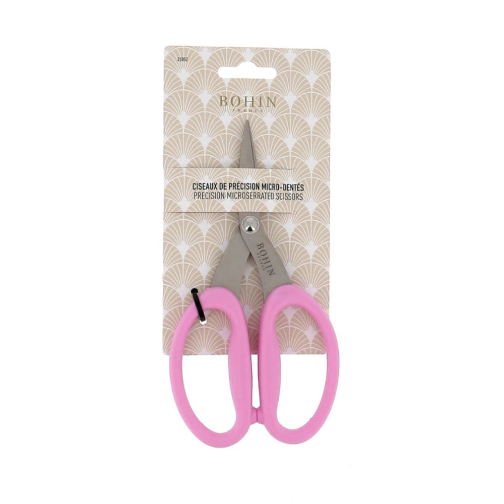 pink and silver scissors in beige packaging