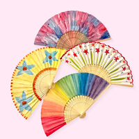 Colorful hand fans on a light pink background