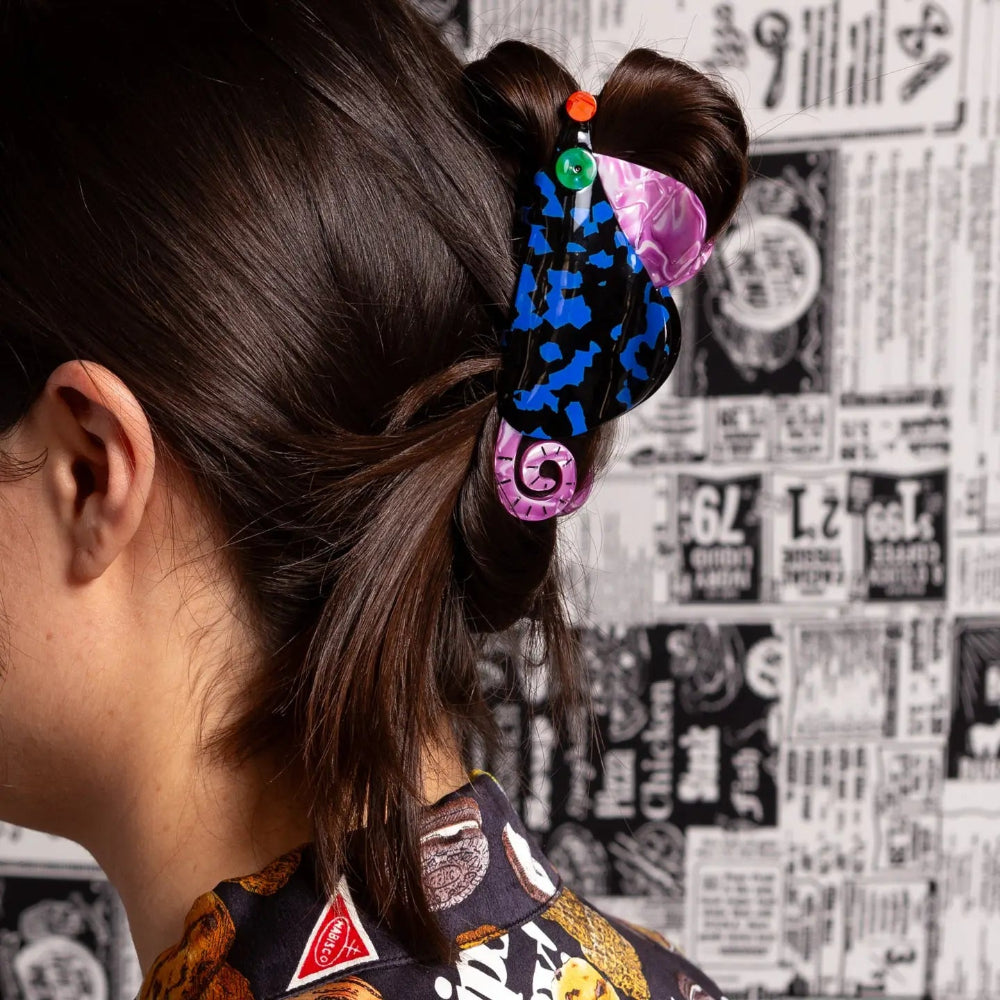 Colorful hair clip in a bun with a patterned background