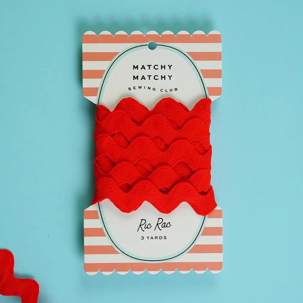 Packaged red ric rac trim with 'Matchy Matchy Sewing Club' label on a blue background