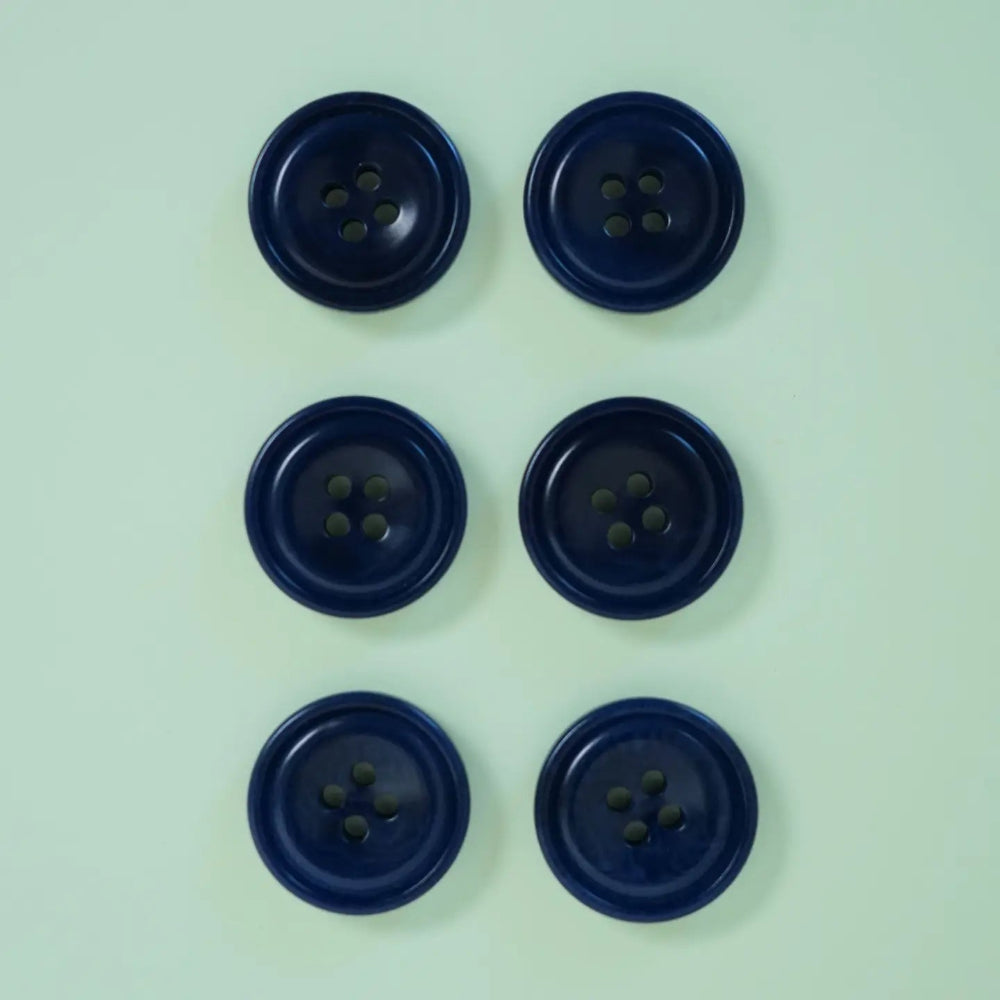 Six blue buttons arranged in two rows on a light green background