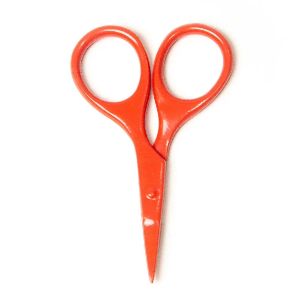 Orange scissors on a white background