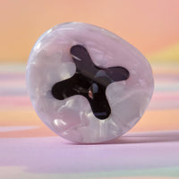 Transparent hair claw with black interior on a gradient background