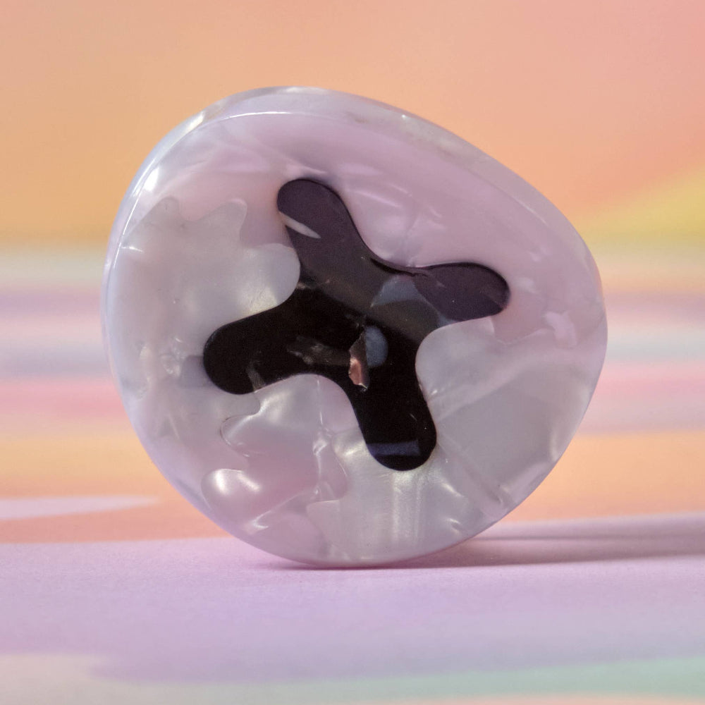 Transparent hair claw with black interior on a gradient background