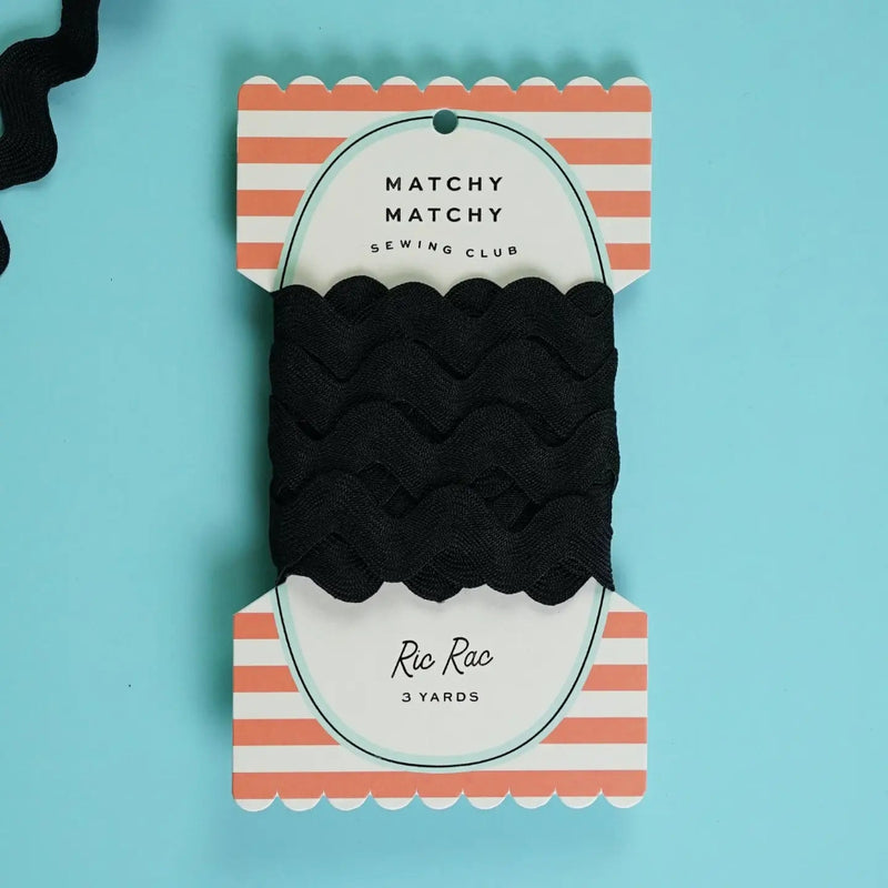 Black ric rac on a striped packaging and a blue background