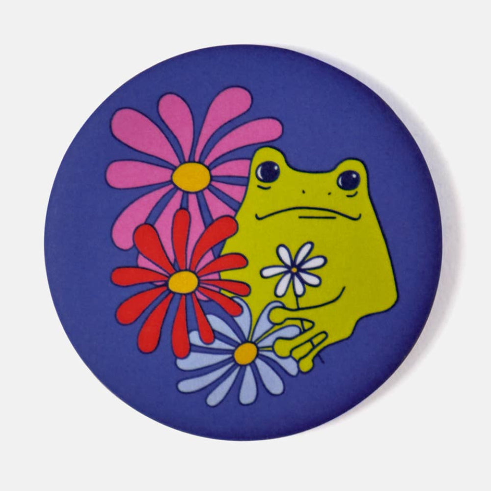 magnet with a green frog and colorful flowers on a blue background
