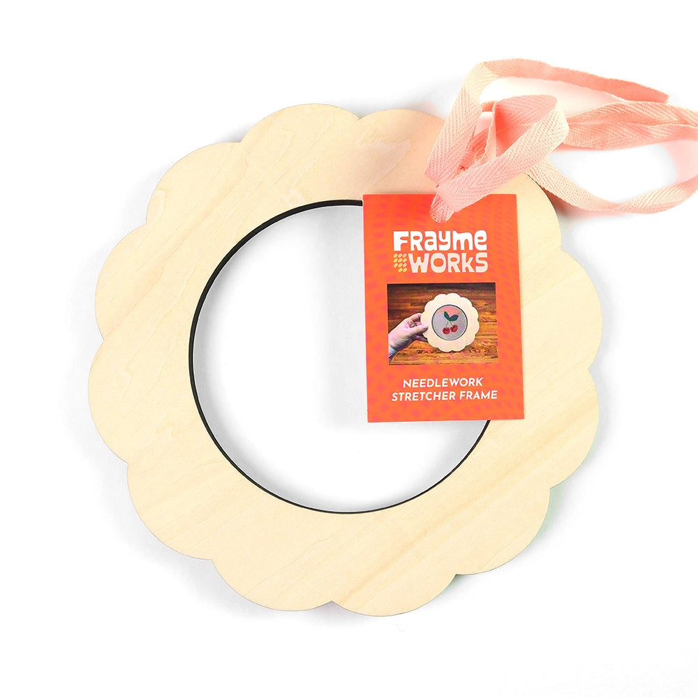 Wooden art frame with 'Frayme Works' label on a white background