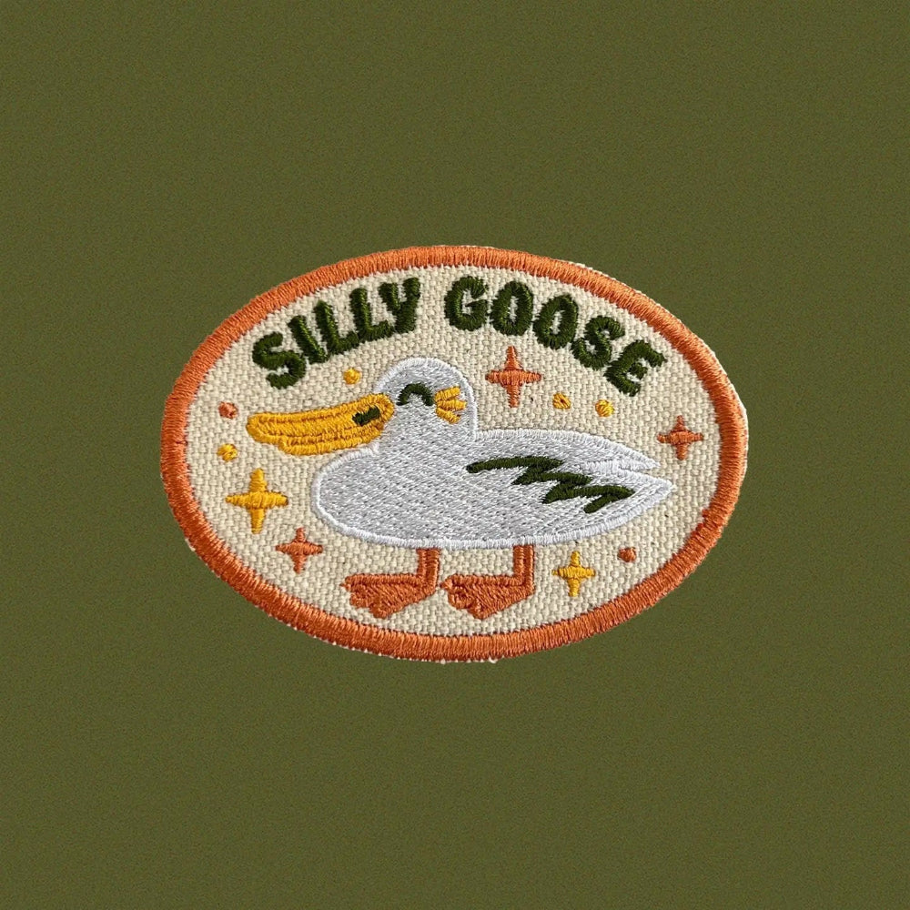 Embroidered patch with a goose design and 'Silly Goose' text on a green background