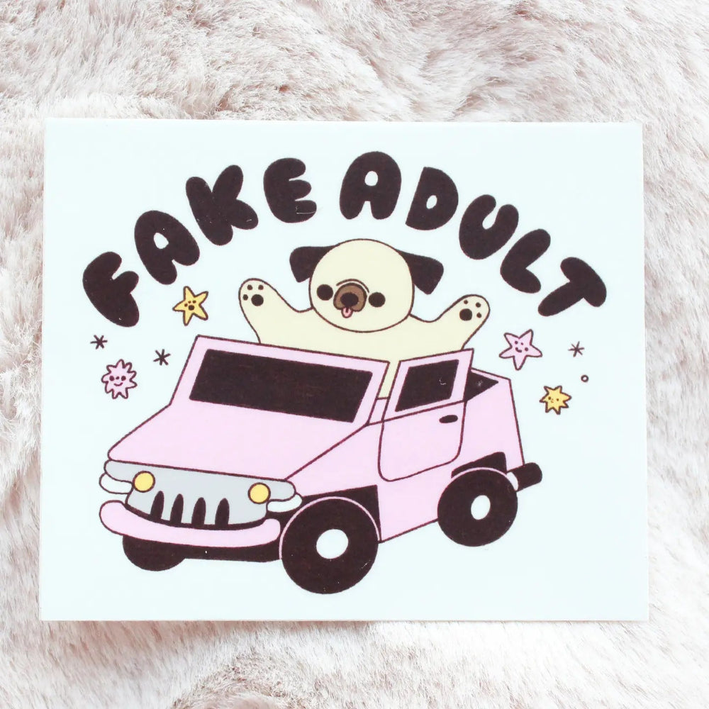 Dog sitting in a pink car with the words "Fake Adult" on top of it, on a background of beige fur
