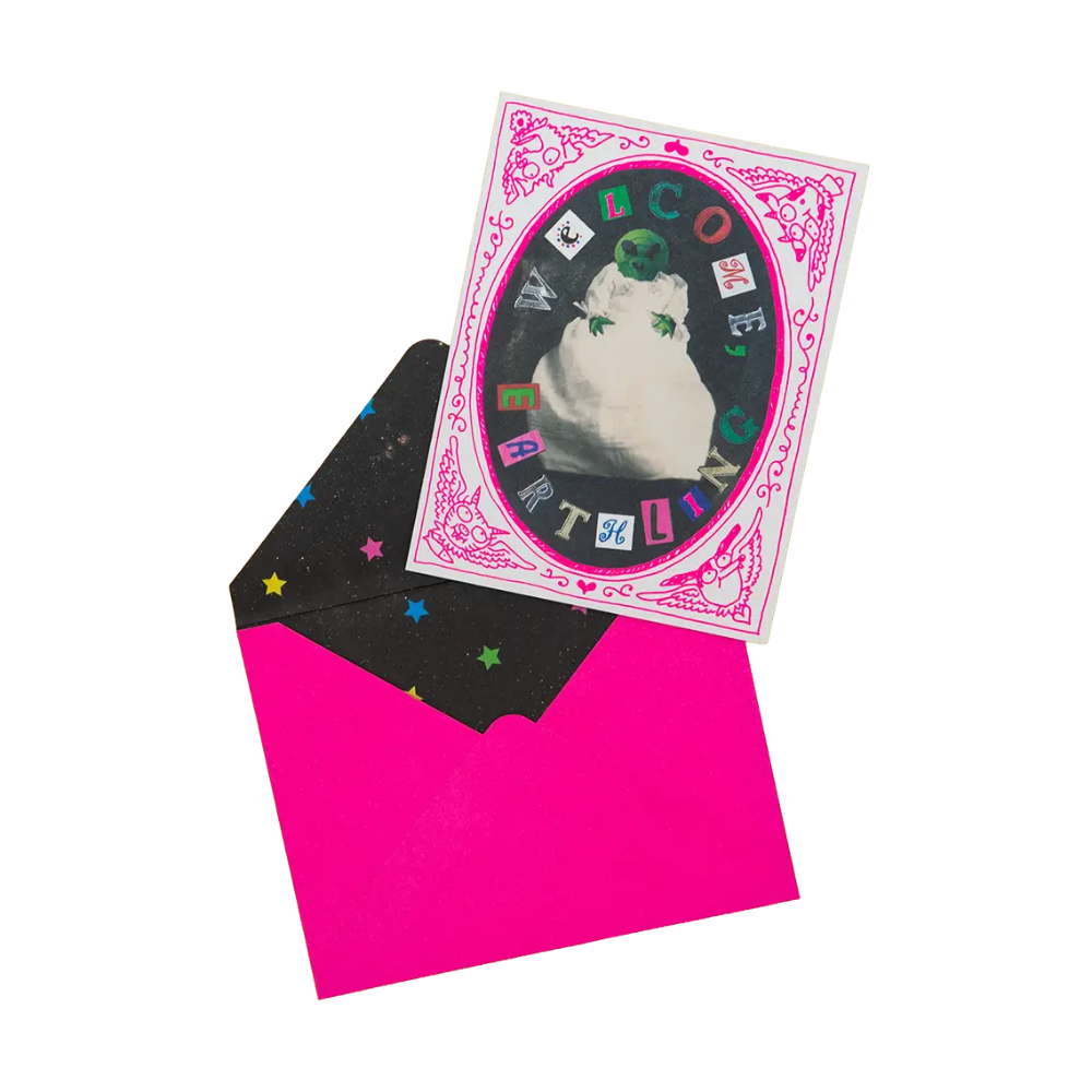 Alien wrapped in a towel on a white and pink card with pink envelope. 