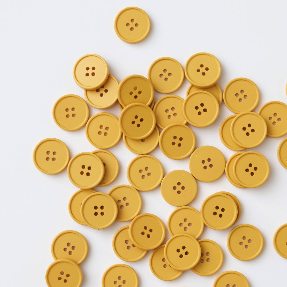 Yellow buttons scattered on a white background