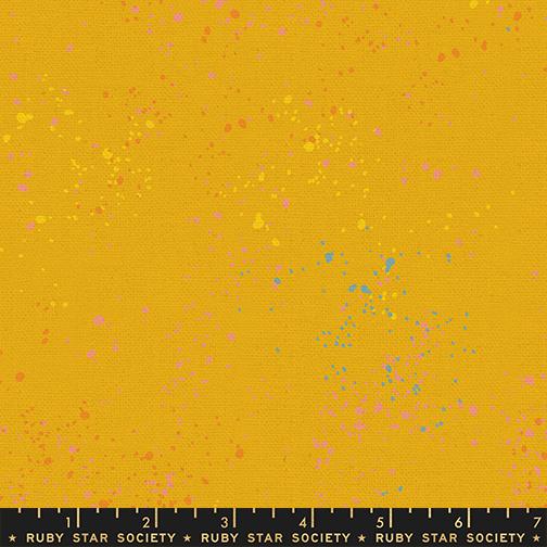Yellow fabric with colorful speckles and a Ruby Star Society label at the bottom.