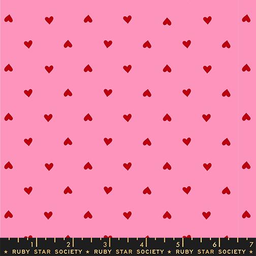 Pink fabric with red heart pattern and Ruby Star Society label at the bottom.