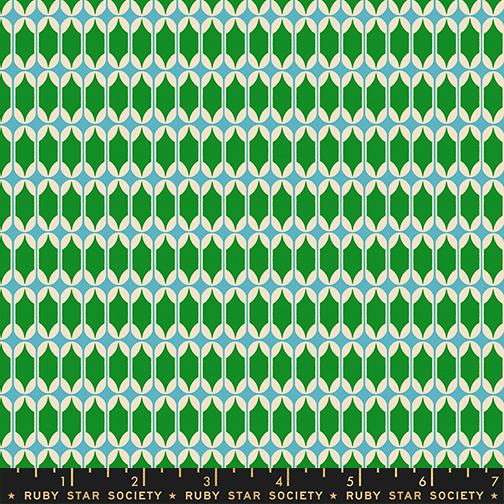 Patterned fabric with green and blue design, featuring a ruler at the bottom for scale.