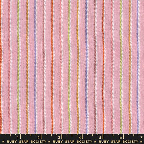Fabric with multicolored vertical stripes on a pink background, featuring the Ruby Star Society label.
