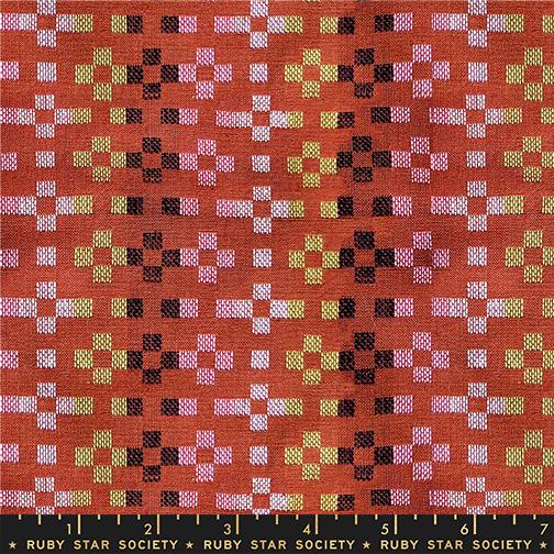 Fabric with geometric pattern on a red background, featuring Ruby Star Society label.