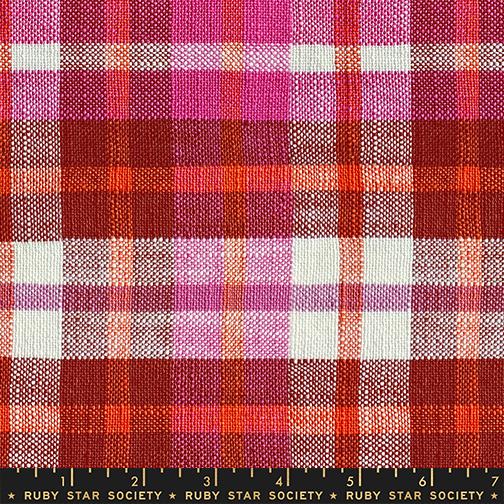 Plaid fabric with red, pink, and white pattern on a checkered background
