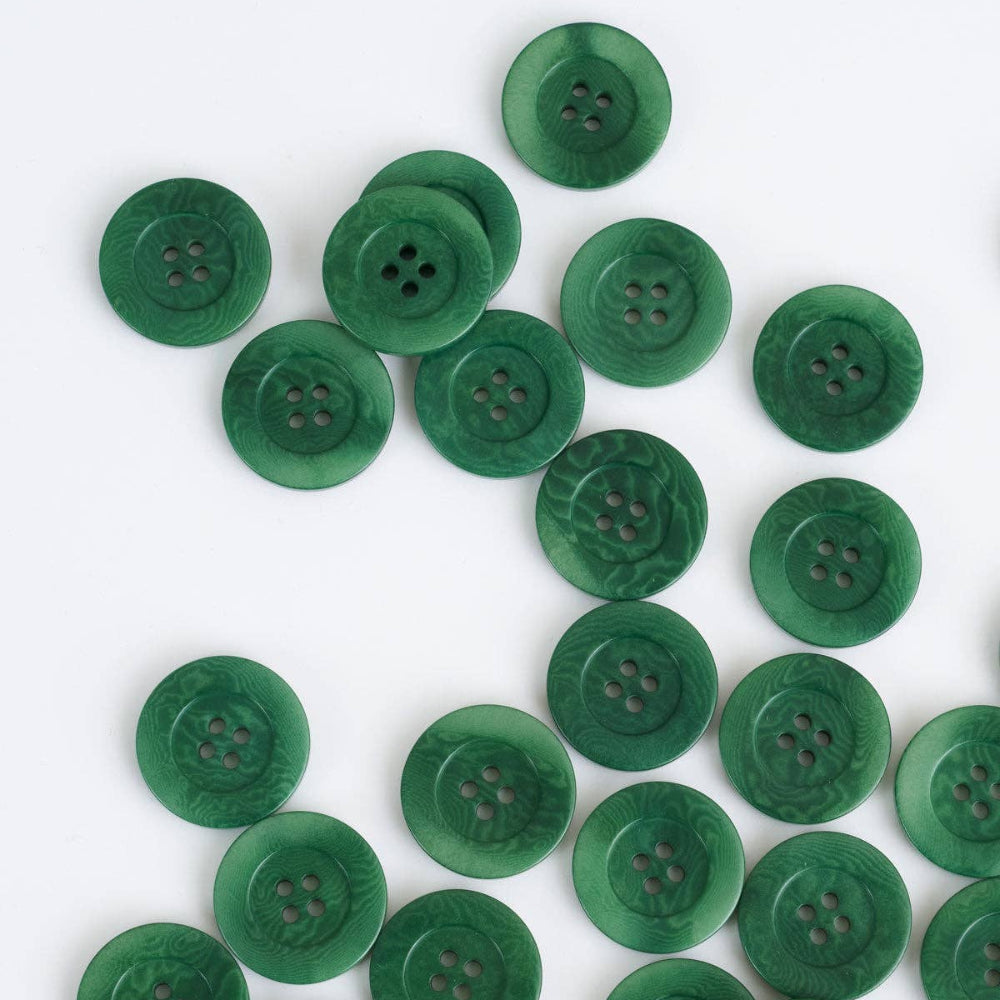 Green buttons scattered on a white background