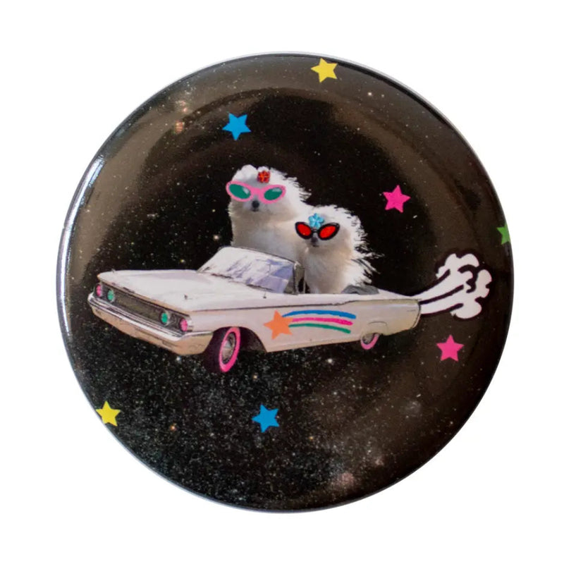 Buttong with 2 white dogs wearing sunglasses in a white car floating through space.