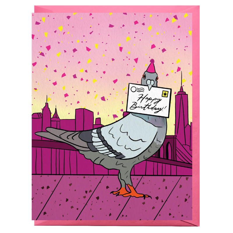 A pink birthday card featuring a cartoon pigeon standing on a bridge with a city skyline in the background and confetti in the sky. The pigeon holds a card that says 'Happy Birthday!'.