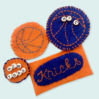 Felt New York Knicks fan accessories on a light blue background
