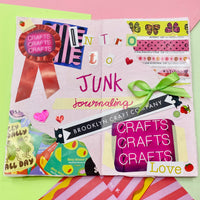 Colorful junk journal with various stickers and text on a pink and green background