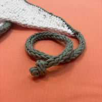 Knit i-cord on a textured orange surface