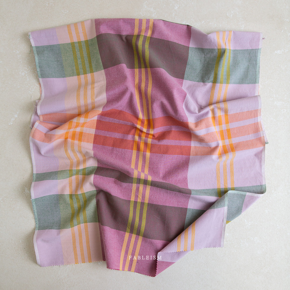 Piece of colorful plaid fabric on a white background