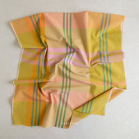 Piece of colorful plaid fabric on a white background