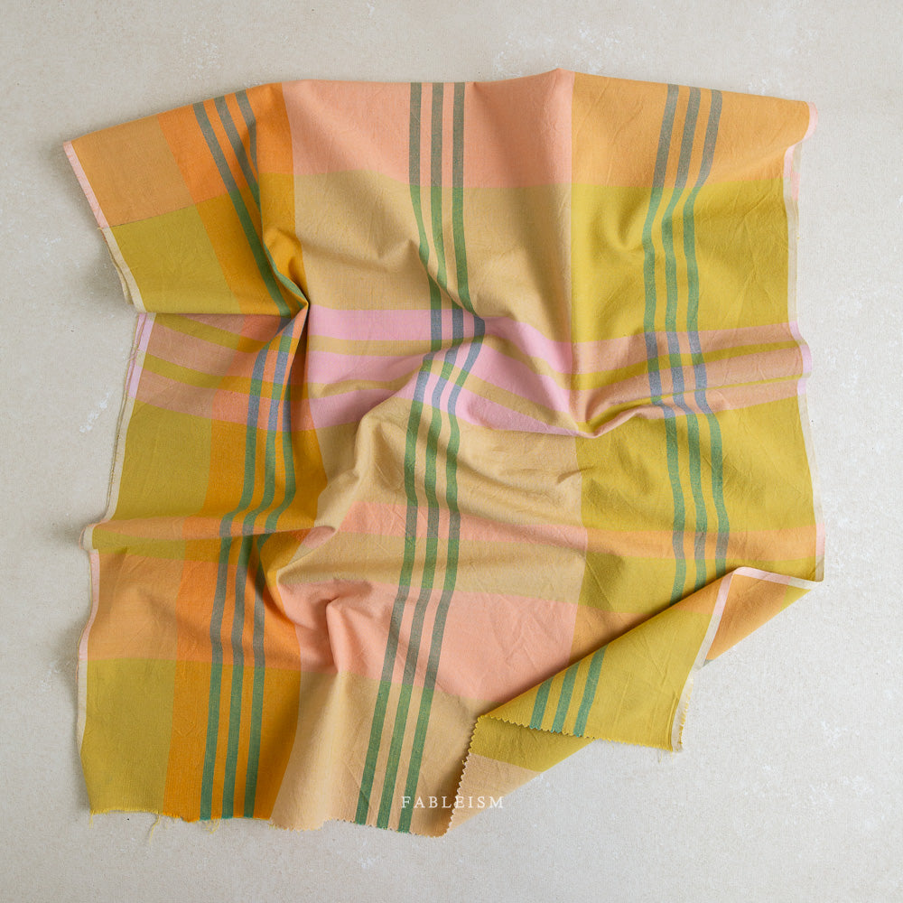 Piece of colorful plaid fabric on a white background