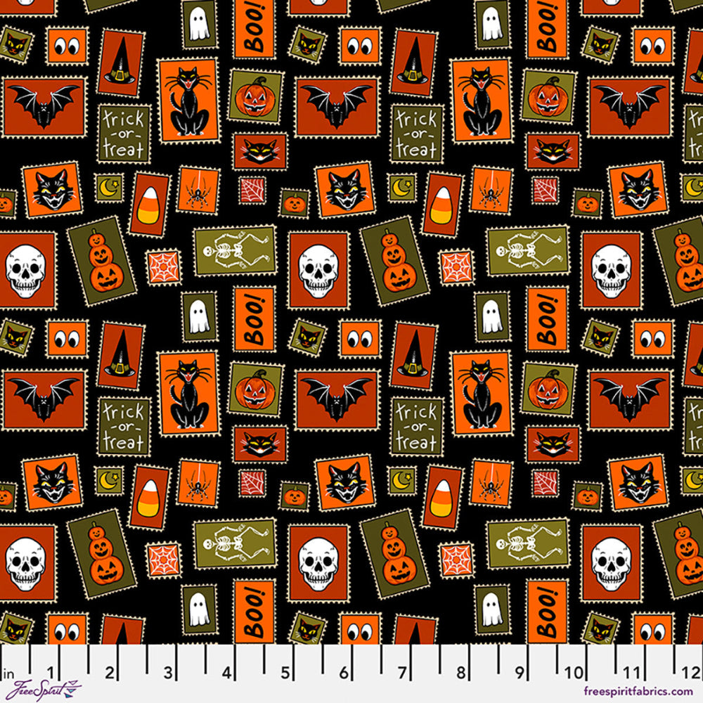 Halloween-themed fabric pattern with various icons on a black background, featuring a ruler for scale.