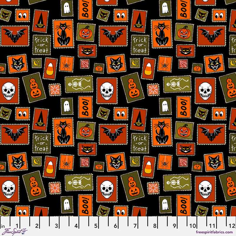 Halloween-themed fabric pattern with various icons on a black background, featuring a ruler for scale.